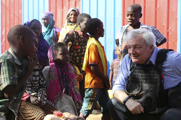 UN Humanitarian Chief Stephen O'Brien, right, meets with drought affected people during his visit to one of Mogadishu IDP camps in Somalia, Monday, March 6, 2017. (AP Photo/Mohamed Sheikh Nor)