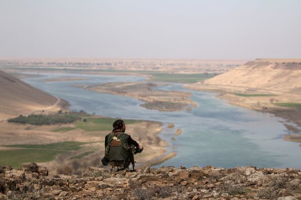 A Syrian Democratic Forces(SDF) fighter rests while looking over the Euphrates River, north of Raqqa city, Syria March 8, 2017. REUTERS/Rodi Said ORG XMIT: GGG-SYR04