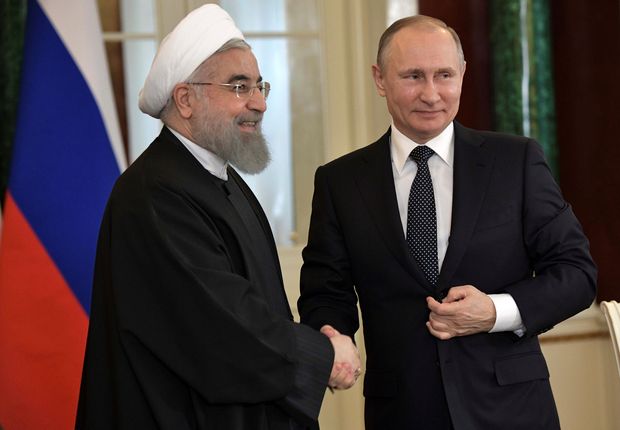 Russian President Vladimir Putin shakes hands with Iranian President Hassan Rouhani during a joint news conference following their meeting at the Kremlin in Moscow, Russia March 28, 2017. Sputnik/Aleksey Nikolskyi/Kremlin via REUTERS ATTENTION EDITORS - THIS IMAGE WAS PROVIDED BY A THIRD PARTY. EDITORIAL USE ONLY. ORG XMIT: MOS23