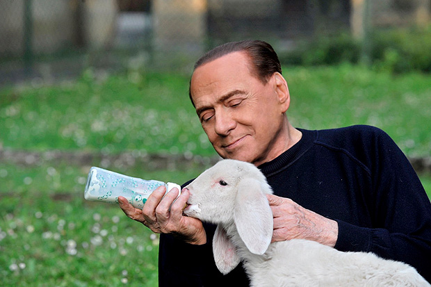Former prime minister Silvio Berlusconi feeds a lamb with a baby bottle in this undated photo released by the Italian League in Defence of Animals and the Environment. Maurizio Calzari/Lega Italiana Difesa Animali e Ambiente/Handout via Reuters ATTENTION EDITORS - THIS PICTURE WAS PROVIDED BY A THIRD PARTY. EDITORIAL USE ONLY. NO RESALES. NO ARCHIVE. ORG XMIT: ROM101