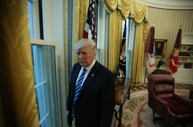 U.S. President Donald Trump stands in the Oval Office following an interview with Reuters at the White House in Washington, U.S., April 27, 2017. REUTERS/Carlos Barria ORG XMIT: WAS309
