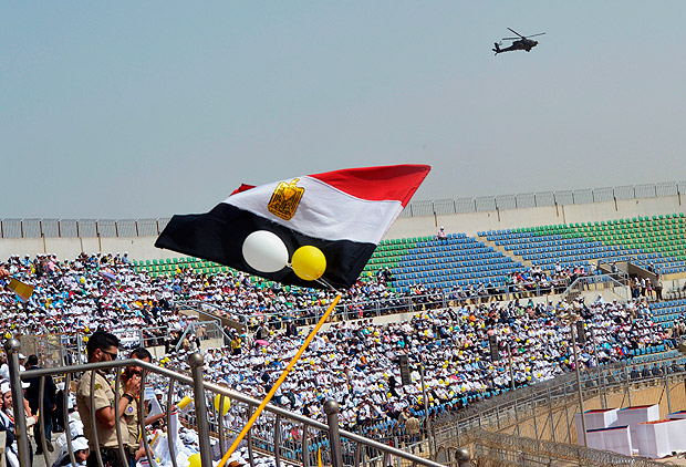 An Egyptian security forces helicopter hovers above the stadium during a mass celebrated by Pope Francis on April 29, 2017 in Cairo. Pope Francis led a jubilant mass for thousands of Egyptian Catholics during a visit to support the country's embattled Christian minority and promote dialogue with Muslims. / AFP PHOTO / KHALED DESOUKI ORG XMIT: 057