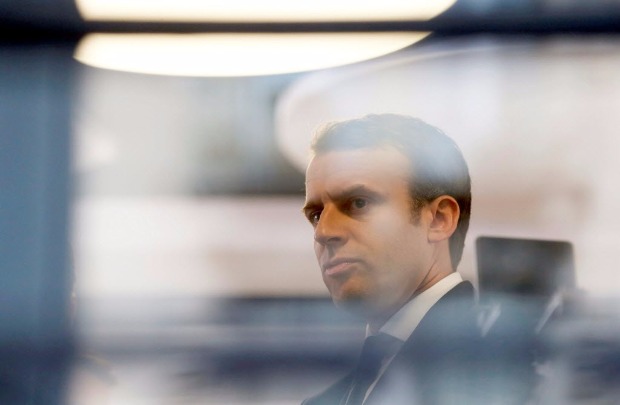 Emmanuel Macron, head of the political movement En Marche!, or Onwards!, and candidate for the 2017 presidential election, is pictured through a window of his hotel during a campaign visit in Rodez, France, May 5, 2017. REUTERS/Regis Duvignau ORG XMIT: SIN100