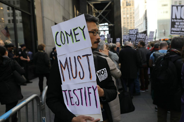 NEW YORK, NY - MAY 10: Protesters gather outside of Trump Tower a day after FBI Director James Comey was fired by President Donald Trump on May 10, 2017 in New York City. Comey was fired Trump only days after he requested more resources from the Justice Department for his bureau's investigation into collusion between the Trump campaign and the Russian government, Spencer Platt/Getty Images/AFP == FOR NEWSPAPERS, INTERNET, TELCOS & TELEVISION USE ONLY ==
