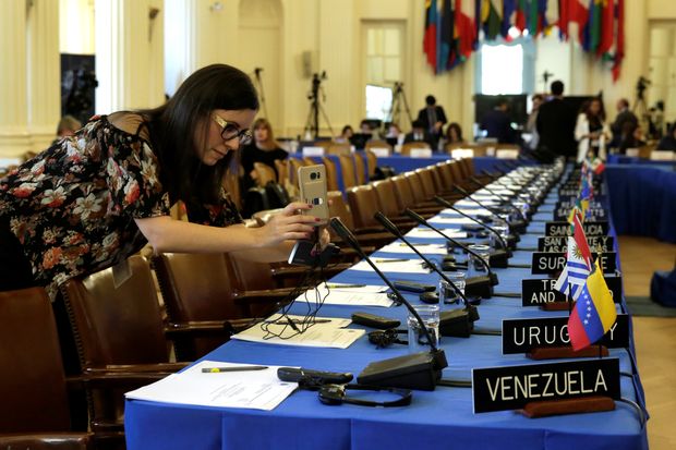 Mulher tira foto de mesa dos chanceleres antes de reunio sobre a Venezuela na sede da OEA, em Washington