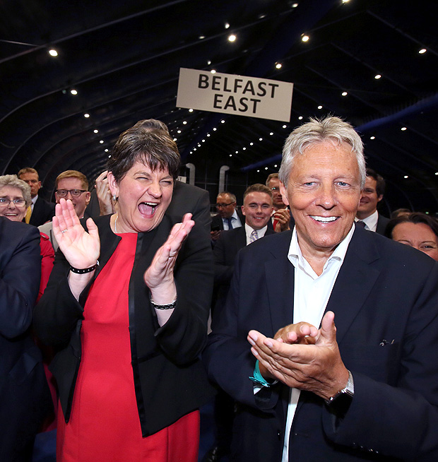 Democratic Unionist Party (DUP) leader Arlene Foster (L) celebrates with Former Democratic Unionist Party (DUP) Leader, Peter Robinson (R) at the counting centre in Belfast, Northern Ireland, early in the morning of June 9, 2017, hours after the polls closed in Britain's general election. Prime Minister Theresa May is poised to win Britain's snap election but lose her parliamentary majority, a shock exit poll suggested on June 8, in what would be a major blow for her leadership as Brexit talks loom. The Conservatives were set to win 314 seats, followed by Labour on 266, the Scottish National Party on 34 and the Liberal Democrats on 14, the poll for the BBC, Sky and ITV showed. / AFP PHOTO / Paul FAITH