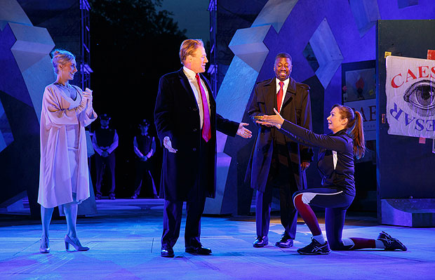 FILE - In this May 21, 2017, file photo provided by The Public Theater, Tina Benko, left, portrays Melania Trump in the role of Caesar's wife, Calpurnia, and Gregg Henry, center left, portrays President Donald Trump in the role of Julius Caesar during a dress rehearsal of The Public Theater's Free Shakespeare in the Park production of Julius Caesar in New York. Teagle F. Bougere, center right, plays as Casca, and Elizabeth Marvel, right, as Marc Anthony. Delta Air Lines is pulling its sponsorship of New York's Public Theater for portraying Julius Caesar as the Donald Trump look-alike in a business suit who gets knifed to death on stage, according to its statement Sunday, June 11, 2017. (Joan Marcus/The Public Theater via AP) ORG XMIT: NYHK703