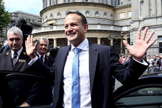Leo Varadkar waves to colleagues as he leaves the parliament in Dublin after being confirmed as taoiseach on June 14, 2017. Leo Varadkar promised a "republic of opportunity" Wednesday after he became Ireland's youngest prime minister and the first who is openly gay. The 38-year-old, who won the leadership of the ruling centre-right Fine Gael party earlier this month, was formally confirmed as taoiseach by parliament. / AFP PHOTO / Paul FAITH