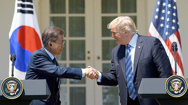 President Donald Trump and South Korean President Moon Jae-in shakes hands in the Rose Garden of the White House in Washington, Friday, June 30, 2017, after making statements. (AP Photo/Susan Walsh) ORG XMIT: DCSW122