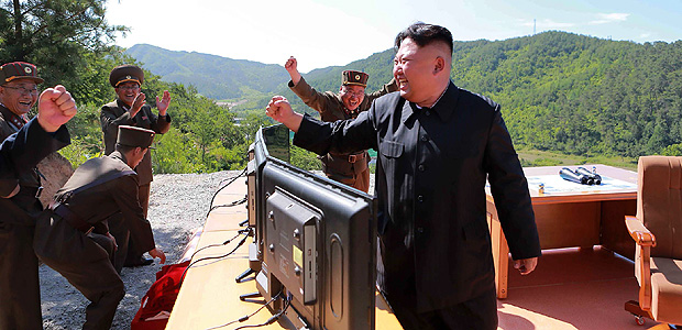 This picture taken and released on July 4, 2017 by North Korea's official Korean Central News Agency (KCNA) shows North Korean leader Kim Jong-Un (R) reacting after the test-fire of the intercontinental ballistic missile Hwasong-14 at an undisclosed location. North Korea declared on July 4 it had successfully tested its first intercontinental ballistic missile -- a watershed moment in its push to develop a nuclear weapon capable of hitting the mainland United States. / AFP PHOTO / KCNA VIA KNS / STR / South Korea OUT / REPUBLIC OF KOREA OUT ---EDITORS NOTE--- RESTRICTED TO EDITORIAL USE - MANDATORY CREDIT "AFP PHOTO/KCNA VIA KNS" - NO MARKETING NO ADVERTISING CAMPAIGNS - DISTRIBUTED AS A SERVICE TO CLIENTS THIS PICTURE WAS MADE AVAILABLE BY A THIRD PARTY. AFP CAN NOT INDEPENDENTLY VERIFY THE AUTHENTICITY, LOCATION, DATE AND CONTENT OF THIS IMAGE. THIS PHOTO IS DISTRIBUTED EXACTLY AS RECEIVED BY AFP. /