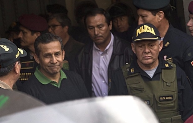Peru's former President Ollanta Humala, left, is escorted out of the Palace of Justice to the Diones prison where ex-President Alberto Fujimori is serving time in Lima, Peru, Friday, July 14, 2017. A judge ordered the arrest of Humala and his wife on Thursday night as they face money laundering and conspiracy accusations tied to a construction scandal involving Brazilian company Odebrecht. (AP Photo/Martin Mejia) ORG XMIT: LIM10