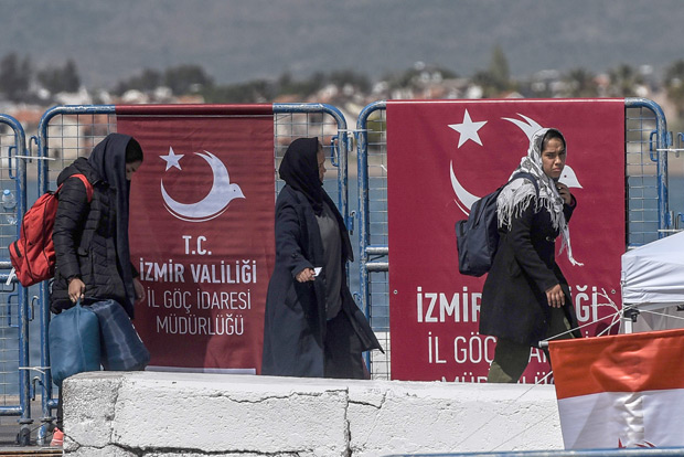 Deported women disembarks from a small Turkish ferry carrying migrants who were deported to Turkey on April 4, 2016 as they arrive at the port of Dikili district in Izmir. Migrants return from Greece to Turkey begun under the terms of an EU deal that has worried aid groups, as Athens struggles to manage the overload of desperate people on its soil. Over 51,000 refugees and migrants seeking to reach northern Europe are stuck in Greece, after Balkan states sealed their borders. Hundreds more continue to land on the Greek islands every day despite the EU deal. / AFP PHOTO / OZAN KOSE ORG XMIT: 5834