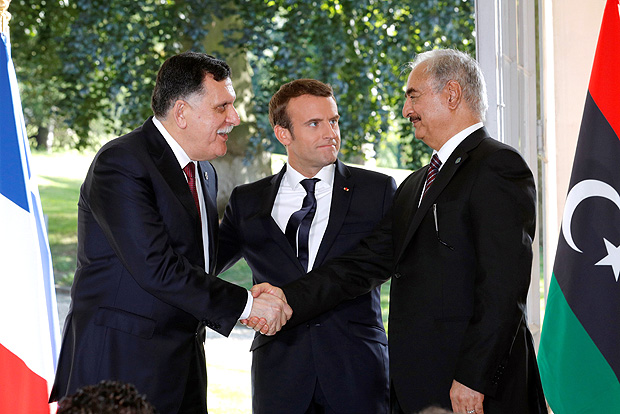 French President Emmanuel Macron arrives with Libyan Prime Minister Fayez al-Sarraj (L), and General Khalifa Haftar (R), commander in the Libyan National Army (LNA), who shake hands after talks over a political deal to help end Libya’s crisis in La Celle-Saint-Cloud near Paris, France, July 25, 2017. REUTERS/Philippe Wojazer ORG XMIT: PAR14