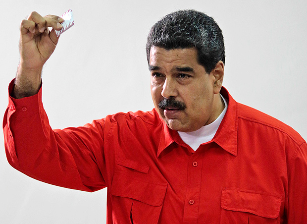 In this photo released by Miraflores Press Office, Venezuela's President Nicolas Maduro shows his ballot after casting a vote for a constitutional assembly in Caracas, Venezuela on Sunday, July 30, 2017. Maduro asked for global acceptance on Sunday as he cast an unusual pre-dawn vote for an all-powerful constitutional assembly that his opponents fear he'll use to replace Venezuelan democracy with a single-party authoritarian system. (Miraflores Press Office via AP) ORG XMIT: XFLL101