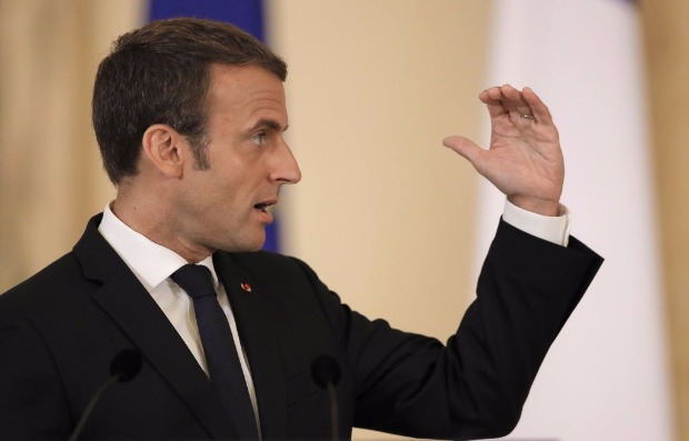 French President Emmanuel Macron gestures during a joint press conference with Romanian counterpart Klaus Iohannis, in Bucharest, Romania, Thursday, Aug. 24, 2017. Macron said Thursday he is 