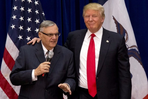 FILE - In this Jan. 26, 2016 file photo, then-Republican presidential candidate Donald Trump is joined by Joe Arpaio, the sheriff of metro Phoenix, at a campaign event in Marshalltown, Iowa. President Donald Trump has pardoned former sheriff Joe Arpaio following his conviction for intentionally disobeying a judge's order in an immigration case. The White House announced the move Friday night, Aug. 25, 2017, saying the 85-year-old ex-sheriff of Arizona's Maricopa County was a "worthy candidate" for a presidential pardon. (AP Photo/Mary Altaffer, File) ORG XMIT: NY117