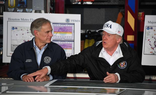 US President Donald Trump (R) sits with Texas Governor Greg Abbott during a briefing on Hurricane Harvey in Corpus Christi, Texas on August 29, 2017. President Donald Trump flew into storm-ravaged Texas Tuesday in a show of solidarity and leadership in the face of the deadly devastation wrought by Harvey -- as the battered US Gulf Coast braces for even more torrential rain