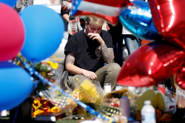 Amigo de uma vtima chora no memorial criado para lembrar mortos e feridos no ataque em Las Vegas