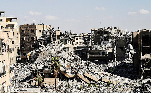(FILES) This file photo taken on October 01, 2017 shows the damage near the central hospital of the embattled northern Syrian city of Raqa. As Syrian Democratic Forces fight to oust the Islamic State group from its last hideouts in Syria's Raqa, the city council-in-exile is already working to bring life back to its devastated home town. / AFP PHOTO / BULENT KILIC