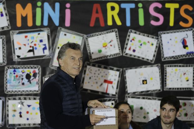 Argentina's President Mauricio Macri casts his vote during midterm legislative elections, at a school in Buenos Aires, Argentina, Sunday, Oct. 22, 2017. Legislative elections in Argentina are giving Macri a chance to win his first friendly congress, while former President Cristina Fernandez is seeking to make a comeback. (AP Photo/Natacha Pisarenko) ORG XMIT: XNP111