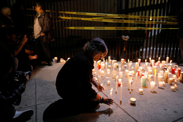 An activist holds candles during a protest against a new security bill, Law of Internal Security, outside Senate building, in Mexico City, Mexico, December 13, 2017. REUTERS/Edgard Garrido ORG XMIT: GGGEGC22