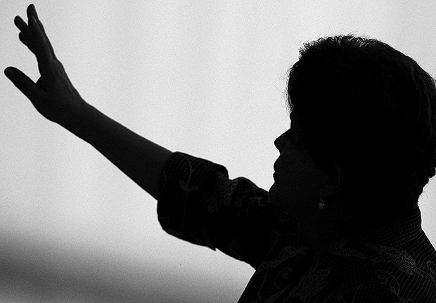 A silhouette of Brazil's President Dilma Rousseff is seen as she gestures during a ceremony where she received the delegation of Brazilian athletes who took part in the 2011 Parapan American Games in Guadalajara, at the Planalto Palace November 24, 2011. REUTERS/Ueslei Marcelino/File Photo ORG XMIT: CDG37