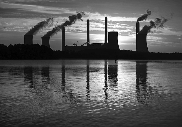 FILE - In this June 3, 2017, file photo, the coal-fired Plant Scherer, one of the nation's top carbon dioxide emitters, stands in the distance in Juliette, Ga. The Trump administration intends to roll back the centerpiece of former President Barack Obama?s efforts to slow global warming, seeking to ease restrictions on greenhouse gas emissions from coal-fired power plants. (AP Photo/Branden Camp, File) ORG XMIT: WX138