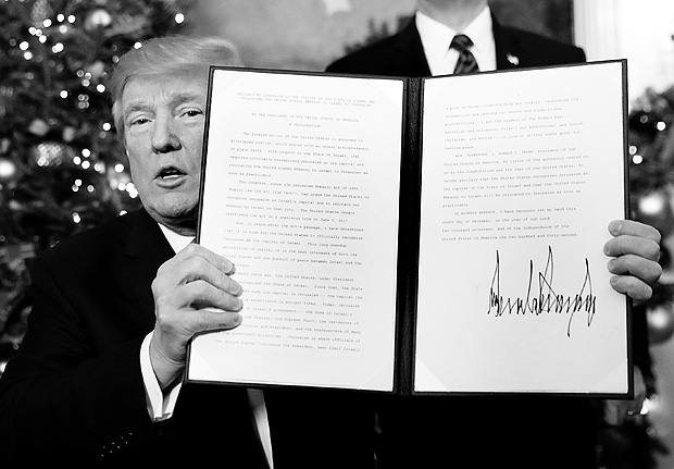 U.S. President Donald Trump holds up the proclamation that announces the United States recognizing Jerusalem as the capital of Israel and moving its embassy there, during an address from the White House in Washington, U.S., December 6, 2017. REUTERS/Kevin Lamarque ORG XMIT: WAS202