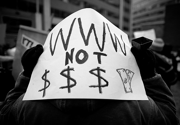 WASHINGTON, DC - DECEMBER 14: Demonstrators rally outside the Federal Communication Commission building to protest against the end of net neutralityrules December 14, 2017 in Washington, DC. Lead by FCC Chairman Ajit Pai, the commission is expected to do away with Obama Administration rules that prevented internet service providers from creating different levels of service and blocking or promoting individual companies and organizations on their systems. Chip Somodevilla/Getty Images/AFP == FOR NEWSPAPERS, INTERNET, TELCOS & TELEVISION USE ONLY 