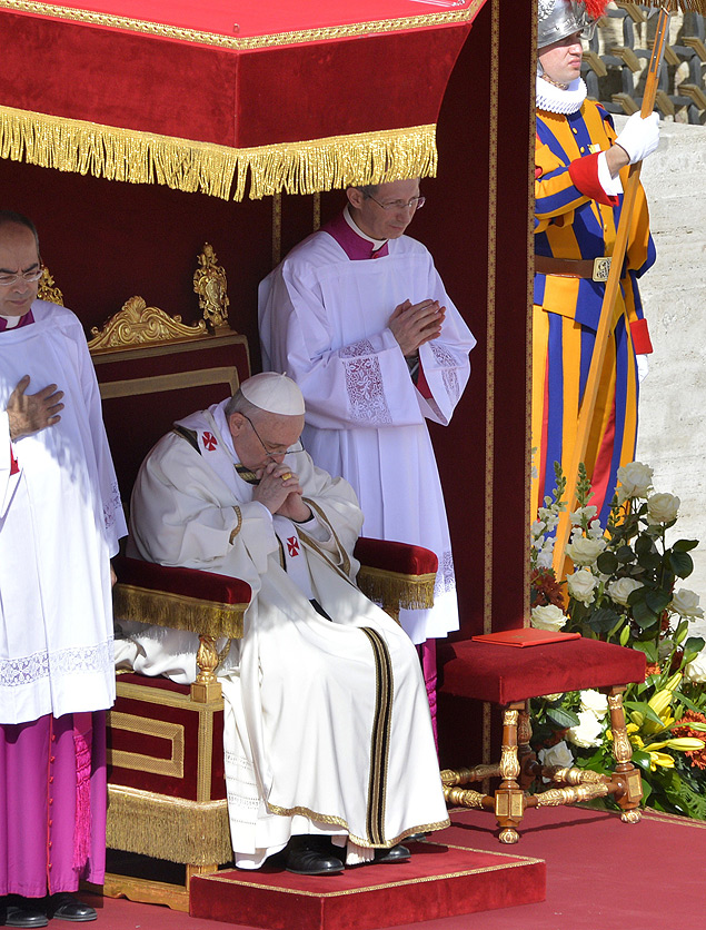 Papa Francisco reza durante sua missa inaugural na praa de So Pedro, no Vaticano