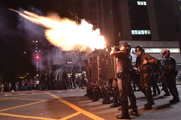 Police fire tear gas grenades at supporters of suspendend president Dilma Rousseff holding a demonstration during her impeachment trial in Sao Paulo, Brazil on August 29, 2016. Rousseff who testified for the first time at her trial urged the Senate in Brasilia to vote against impeaching her denying charges that she fiddled government accounts. / AFP PHOTO / NELSON ALMEIDA