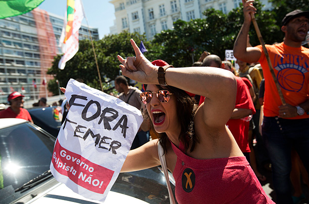 Manifestante protesta na praia de Copacabana, no Rio de Janeiro