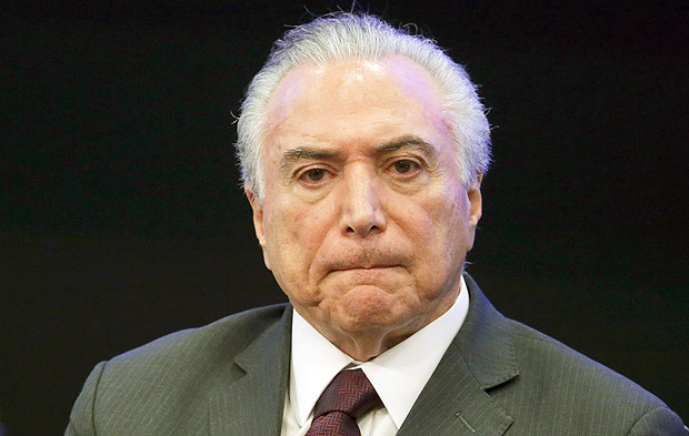 FILE - In this May 8, 2017, file photo, Brazil's President Michel Temer listens in during a event at the Brazilian Institute of Research in Brasilia, Brazil. Temer is denying a report that he endorsed the alleged bribing of a jailed former congressman to keep him quiet. The allegation made in a Globo News report on Wednesday, May 17, represents a potentially significant blow to President Temer. His administration has lurched from one crisis to another since he took office just over a year ago. (AP Photo/Eraldo Peres, File) ORG XMIT: XLAT102