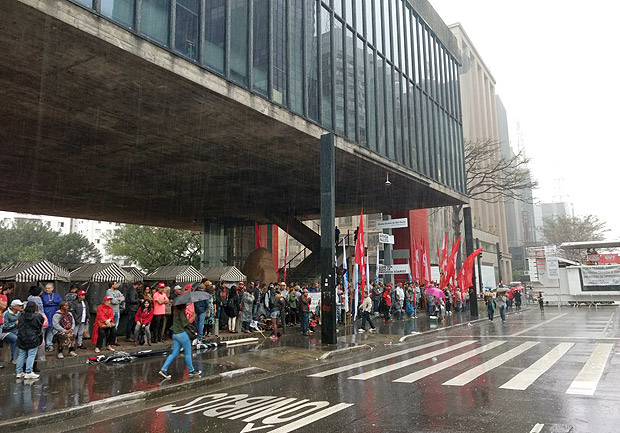 Manifestantes se protegem da chuva enquanto aguardam incio da manifestao, marcada para as 15h.