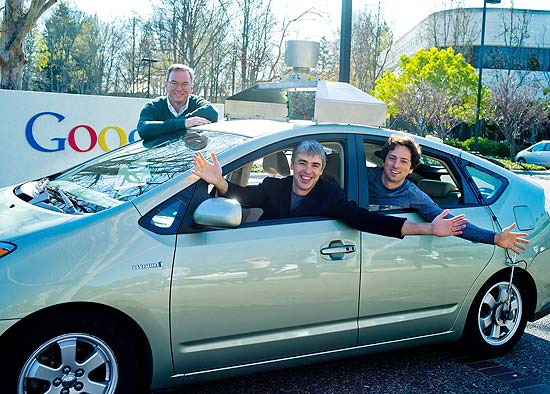 Eric Schmidt, Larry Page, Sergey Brin (da esq. para a dir.) e o carro sem motorista desenvolvido pelo Google