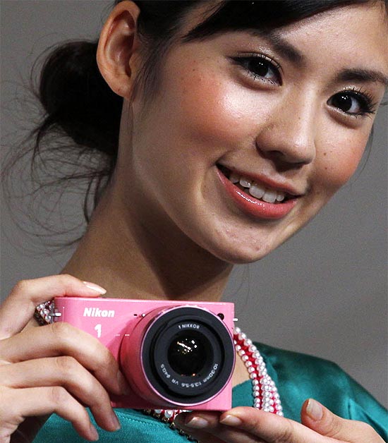 Modelo posa com a câmera Nikon 1 J1 durante evento em Tóquio