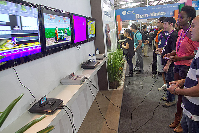 Pessoas jogam videogames antigos durante a Campus Party de 2013, em So Paulo