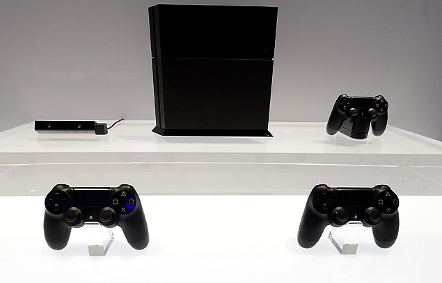Console PlayStation 4, com controles e cmera, expostos durante feira de games E3 em junho de 2013
