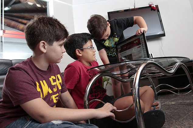 Mateus Luz, 11 (camisa preta), assiste a vdeos de games no YouTube com os colegas durante as fris em casa, em Braslia