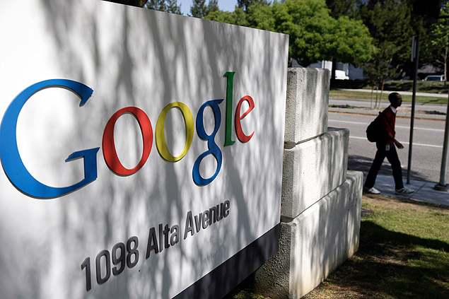 FILE - In this June 5, 2014 file photo, a man walks past a Google sign at the company's headquarters in Mountain View, Calif. Google may have to pay more than half a billion dollars for an unorthodox stock split aimed at ensuring co-founders Larry Page and Sergey Brin retain control over the Internet&#146;s most profitable company. (AP Photo/Marcio Jose Sanchez, File) ORG XMIT: NYBZ154