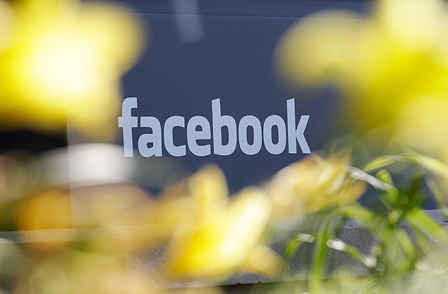 FILE - This Friday, May 18, 2012, file photo shows Facebook's headquarters behind flowers in Menlo Park, Calif. Facebook is stepping up its efforts to fight Ebola by adding a button designed to make it easier for its users to donate to charities battling the disease. (AP Photo/Paul Sakuma, File) ORG XMIT: NYBZ176
