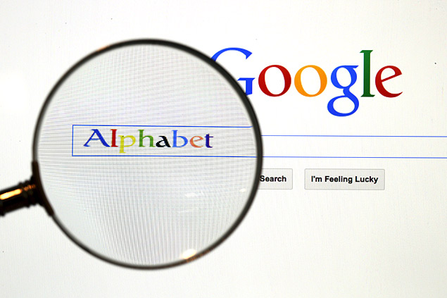 A Google search page is seen through a magnifying glass in this photo illustration taken in Berlin, August 11, 2015. Google Inc is changing its operating structure by setting up a new company called Alphabet Inc, which will include the search business and a number of other units. REUTERS/Pawel Kopczynski ORG XMIT: BER800