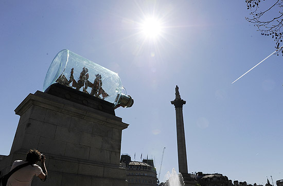 Yinka Shonibare 's installation "Nelson's Ship in a Bottle" sits on the Fourth Plinth after being unveiled in Trafalgar Square, in central London May 24, 2010. The installation is a scale replica of Vice Admiral Lord Nelson's ship, HMS Victory, in a giant bottle, and is the first commission on the Fourth Plinth to specifically reflect the historical symbolism of Trafalgar Square. REUTERS/Paul Hackett (BRITAIN - Tags: ENTERTAINMENT CITYSCAPE SOCIETY TRAVEL)