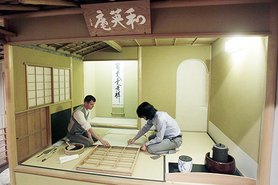 British Museum employees Senior Conservator of Japanese Paintings Keisuke Sugiyama, right, from Japan and Conservator of Japanese Paintings Eoin Kelly pose for photographs as they prepare to repaper the museum's Japanese teahouse in London, Tuesday, June 1, 2010. On Wednesday June 2 visitors will be able to watch traditional tools, materials and techniques being used to repaper the 'shoji' (sliding lattice doors and a window) of the teahouse which was built in 1990 as an adaptation of the traditional Kyoto style for the opening of the museum's Japanese galleries. (AP Photo/Matt Dunham) 