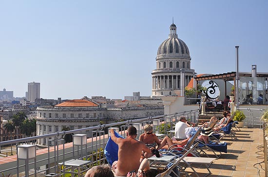 Turistas tomam sol no terrao do hotel Saratoga, em Havana