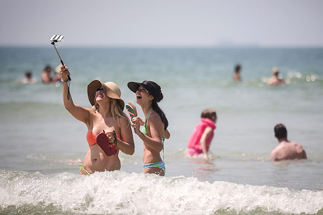 Banhistas usam pau de selfie na praia de Maresias, litoral norte de São Paulo