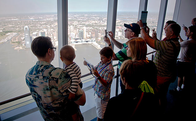 Visitors to One World Observatory make pictures and view parts of New Jersey after a ribbon-cutting ceremony, Friday, May 29, 2015, in New York. The World Trade Center observatory officially opened to the public giving visitors a view of the city and its surroundings from above 1,250 feet, with sight lines stretching 50 miles past the Manhattan skyline. (AP Photo/Bebeto Matthews) ORG XMIT: NYBM110