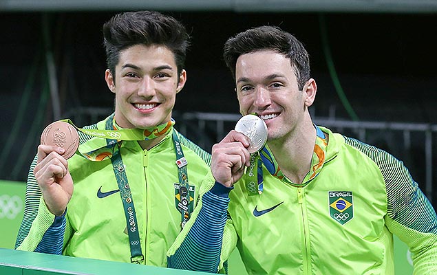 Brazil's Arthur Mariano (L) and Brazil's Diego Hypolito celebrate after the men's floor event final of the Artistic Gymnastics at the Olympic Arena during the Rio 2016 Olympic Games in Rio de Janeiro