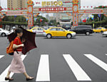 Mulher passa em frente a decoração para comemoração do 100º aniversário da República da China em frente ao escritório presidencial em Tapei, em Taiwan