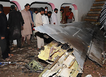 Paquistaneses observam destroos do avio que caiu prximo  capital do pas, Islamabad